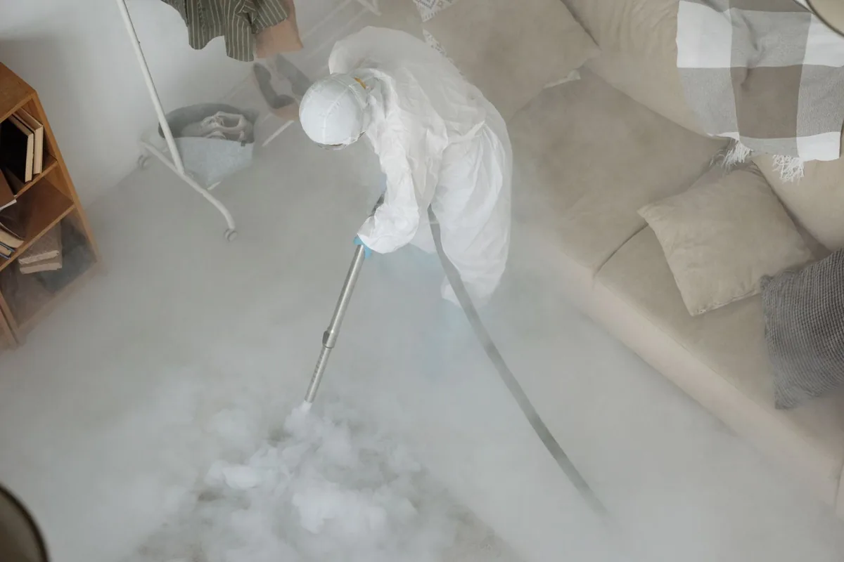 Biohazard cleanup technician in protective equipment, Trenton, MO
